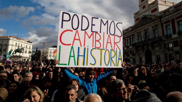 A Podemos party supporter holds a placard reading 'We can change the history' at the end of a march on January 31, 2015 in Madrid, Spain